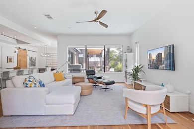 Living room with wood finished floors, ceiling fa