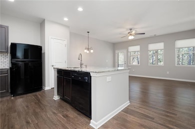 Kitchen with tasteful LVP flooring, plenty of natu