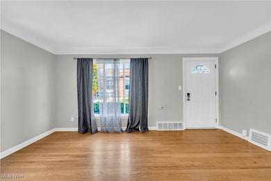 Foyer entrance featuring plenty of natural light and light wood-type flooring