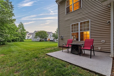 View of green lawn featuring a patio area and a re