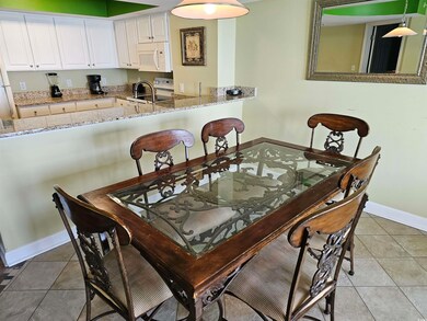Dining room featuring baseboards and light tile patterned floors