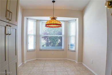 Unfurnished dining area featuring light tile patte