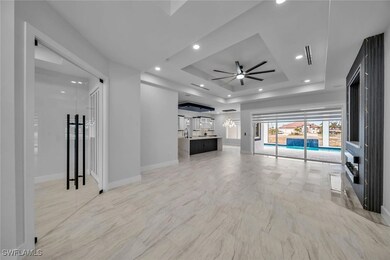 Unfurnished living room featuring ceiling fan, mar