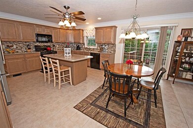 Mosaic glass tile backsplash accents the glazed ma