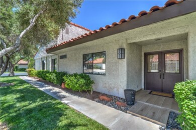 View of exterior entry with stucco siding, a tiled