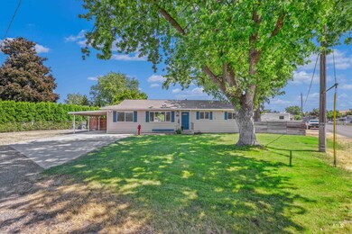 Ranch-style house with concrete driveway and an attached carport
