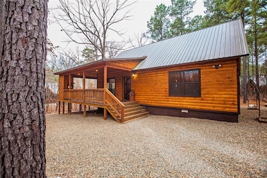 View of front facade with a metal roof, crawl space, and stairs