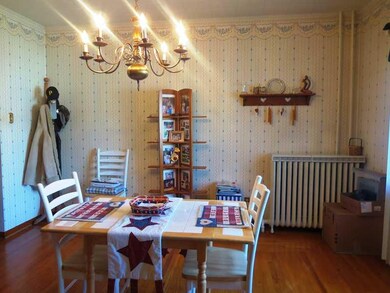 Dining Room. with its hardwood floors,  wallpaper 
