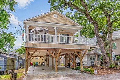 View of front of house featuring ceiling fan, a ca