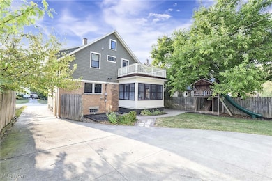 Back of house featuring a balcony and a playground