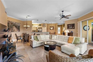 Living area with ceiling fan with notable chandeli