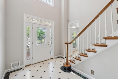 Tiled entrance foyer with a high ceiling, a wealth
