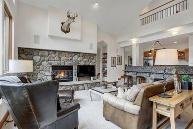 Carpeted living area featuring a fireplace, high vaulted ceiling, and recessed lighting