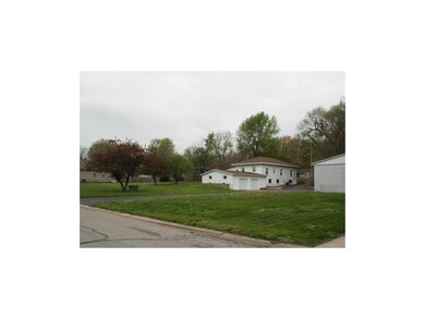Attached garage side entry view with driveway goin