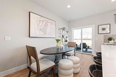 Dining space with light wood-style floors and recessed lighting