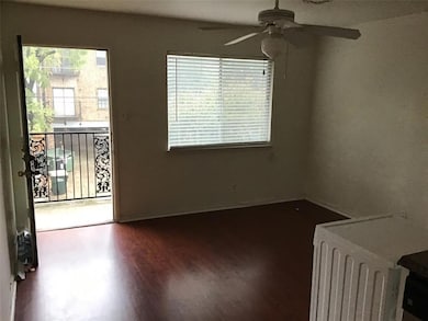 Empty room featuring ceiling fan and dark wood-st