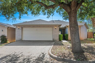 Ranch-style home featuring large front yard shade