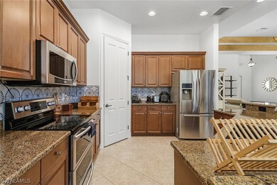 Kitchen with granite countertops, light tiled floo
