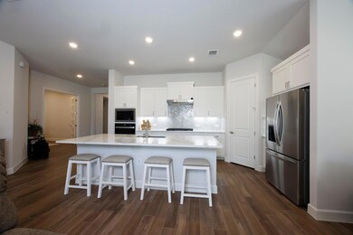 Kitchen featuring stainless steel fridge with ice