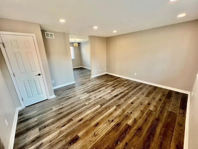 Unfurnished room with dark hardwood / wood-style f
