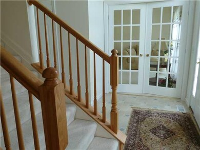 Foyer. Foyer showing oak stair railings and french