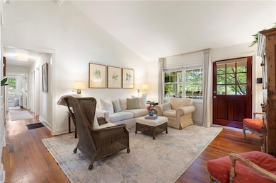 Living room featuring hardwood / wood-style floors and high vaulted ceiling