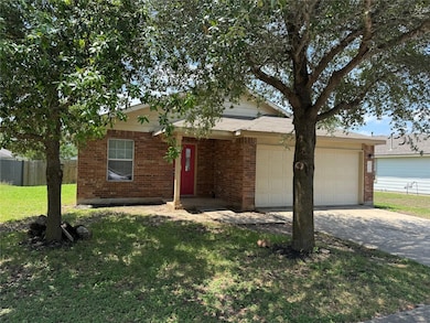 View of front of house with a garage, brick sidin