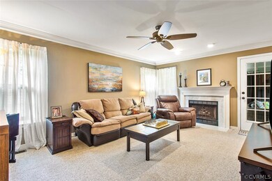 Family room with neutral carpet, crown molding, ga