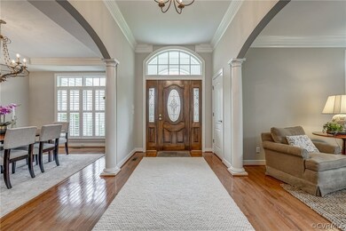 Entryway featuring a notable chandelier, plenty of