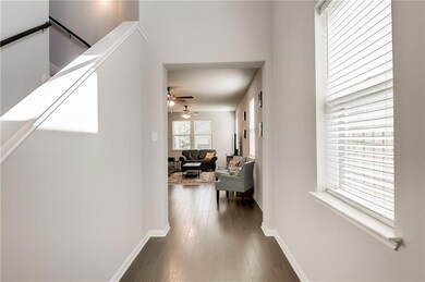 Corridor with baseboards and dark wood-style floo