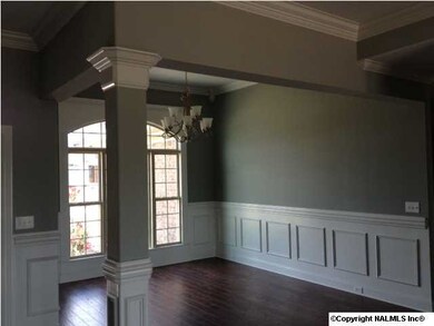 Beautiful decorative post,a high ceiling, hand scrapped hardwood and elegant lighting add a special flair to this over sized dining room. Ample room for a large table and china cabinet or buffet. Electrical outlets are located at the edge of the floor tri