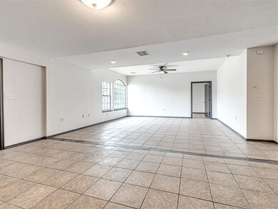 Unfurnished room featuring a ceiling fan and light tile patterned flooring