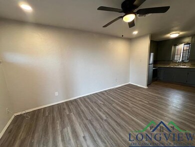 Unfurnished living room featuring baseboards, dark