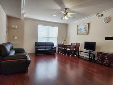Living/dining combo with ceiling fan and wood floo