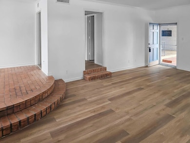 Unfurnished living room with visible vents, basebo