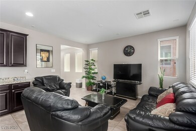Living area featuring visible vents and light tile