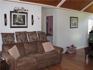 Living room also has vaulted ceilings.