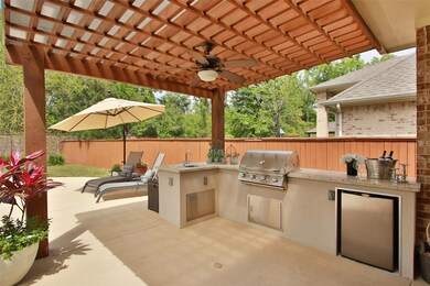 Underneath the rainproof Pergola you will find a great outdoor kitchen featuring a stainless steel built in gas grill, a mini fridge, a sink with storage area underneath with a beautiful granite counter top.