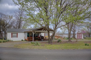 View of front of house featuring a wooden deck, an