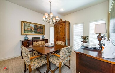 Formal light filled dining area with carpet.