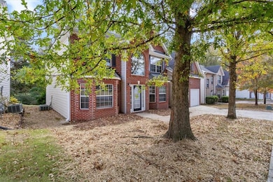 View of front of house featuring a garage, brick siding, and concrete driveway