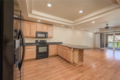 Kitchen with ceiling fan, black appliances, kitche