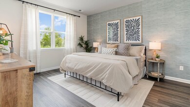 Bedroom with visible vents, wallpapered walls, an 