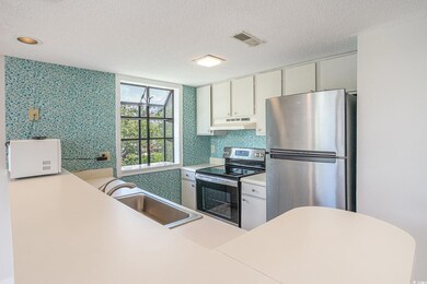 Kitchen with stainless steel appliances, a sink, u
