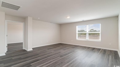 Empty room with dark hardwood / wood-style floorin