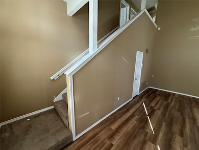 Stairs with wood finished floors and baseboards