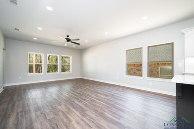 Unfurnished living room with ceiling fan and dark 