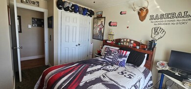 Bedroom featuring a closet and a textured ceiling