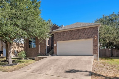 Ranch-style home with concrete driveway, brick si