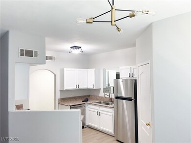 Kitchen featuring stainless steel appliances, a si